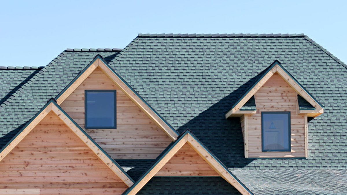 Finished architectural shingle roof with cedar-sided gables and dormers, by Fine Roofing and Remodeling